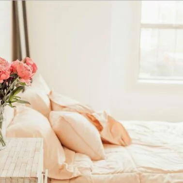 Schlafzimmer einrichten Tipps: Bett mit pastellfarbener Bettwäsche